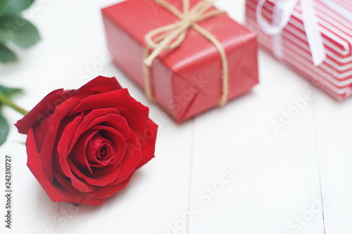 Lovely red color gift box decorated with mini red heart figure and beautiful rose flower  sweet valentine present concept  background and texture for valentine day