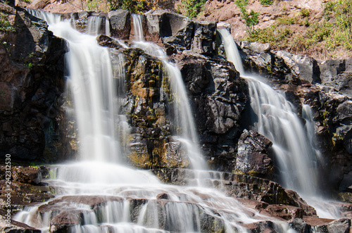 Daytime long exposure of Gooseberry Falls waterfalls at the state park in Minnesota in summer. Close up view
