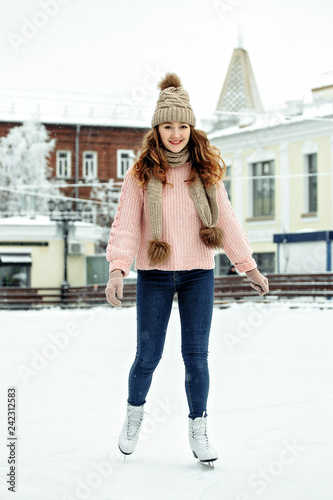 Attractive young woman ice skating during winter © matilda553