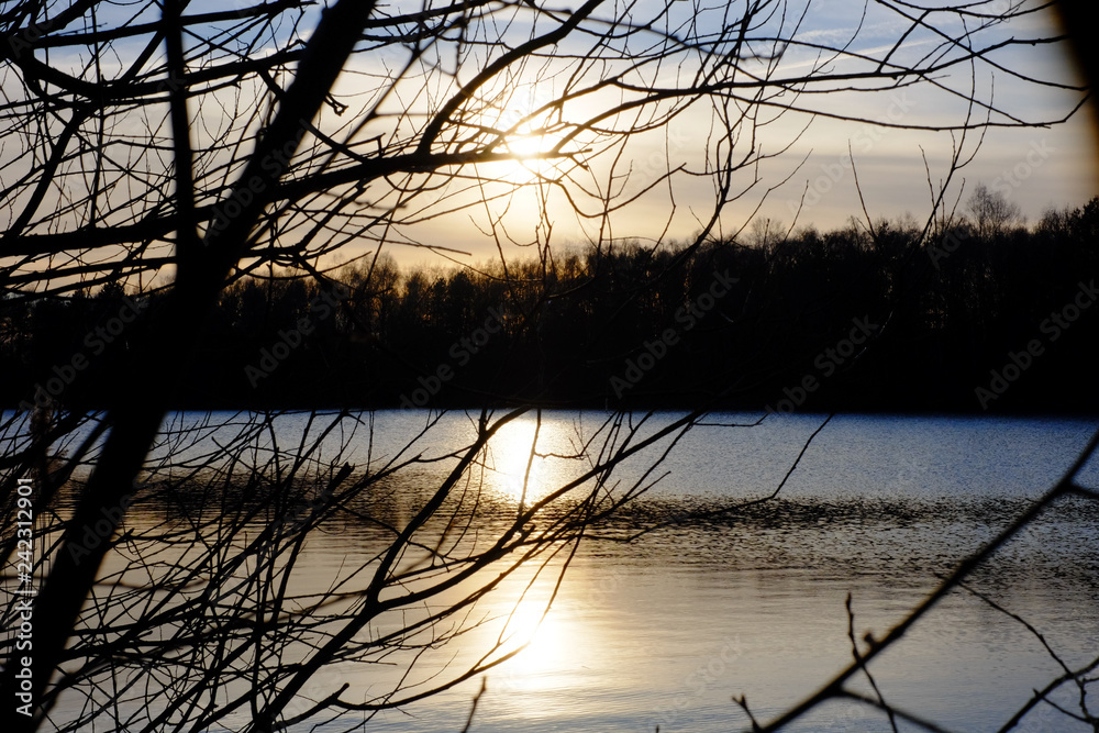 Fototapeta premium Beautiful lake and forest landscape during a colorful and dramatic sunset