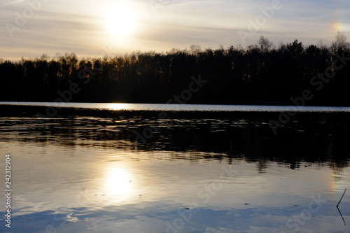 Beautiful lake and forest landscape during a colorful and dramatic sunset