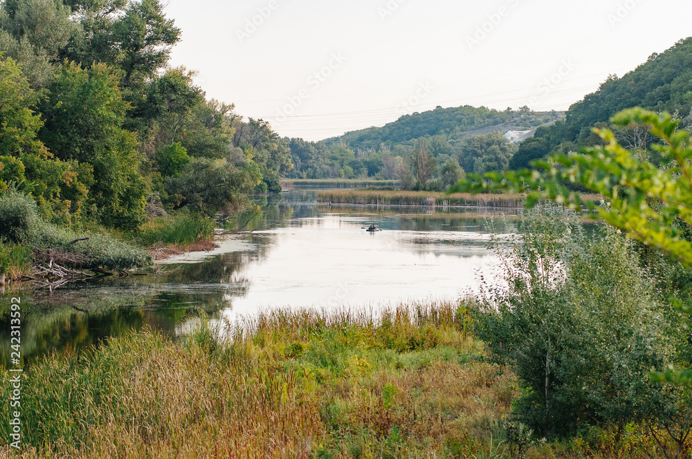 Safety life. Sunny day a calm river in summer. Beauty wild nature landscape. Ecology concept. Environmental protection. Water without pollution. Reserve of nature. Wild planet