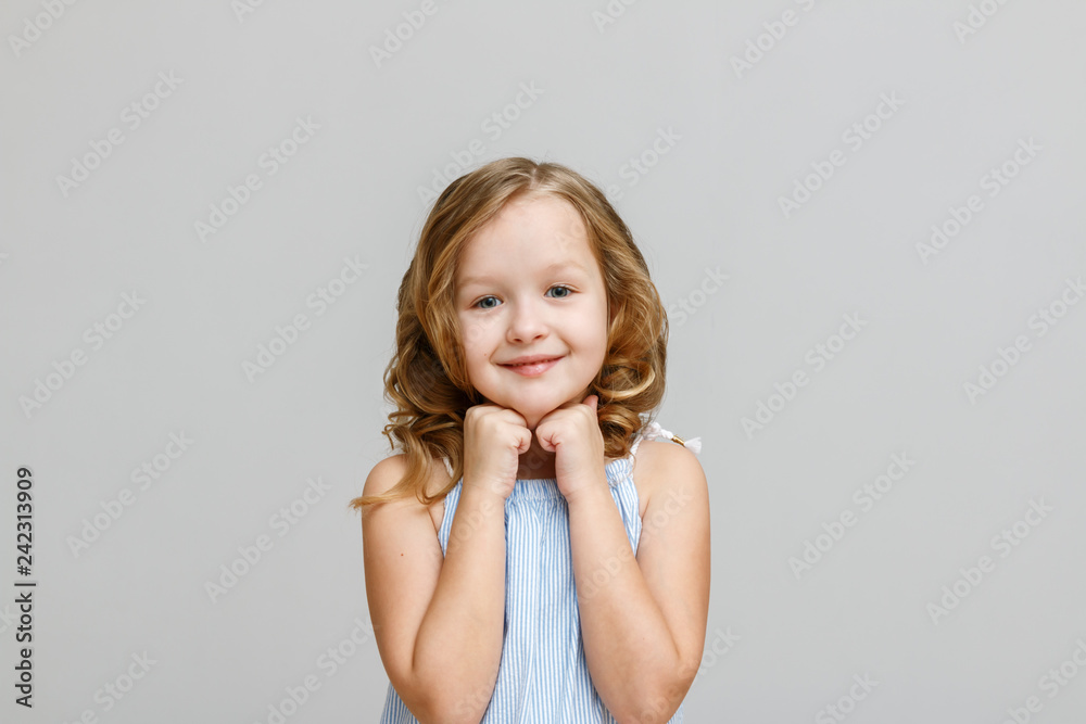 Portrait of a happy smiling little child girl on gray background Portrait of a happy smiling little child girl on gray background