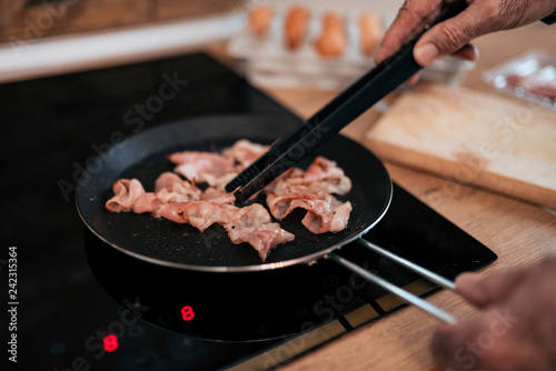 Preparing delicious bacon in a pan.