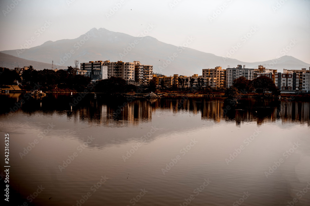 Landscape shot of mountains and lake water during daylight.
