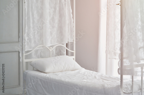 The white bed is in the sun-warmed bedroom in the morning. White bedroom in the morning.Do not focus on objects.