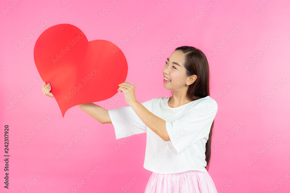 valentine day concept. Beautiful smiley asia girl with pink background copy space isolated. valentine day concept. Beautiful smiley asia girl with pink background copy space isolated.