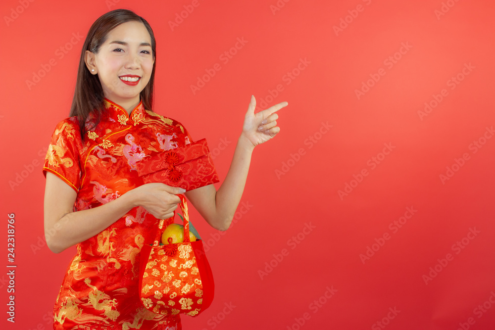 chinese new year beautiful happy smiley asia chiness girl ware Qipao Oriental Chic Cheongsam with red background copy space isolated chinese new year beautiful happy smiley asia chiness girl ware Qipao Oriental Chic Cheongsam with red background copy space isolated