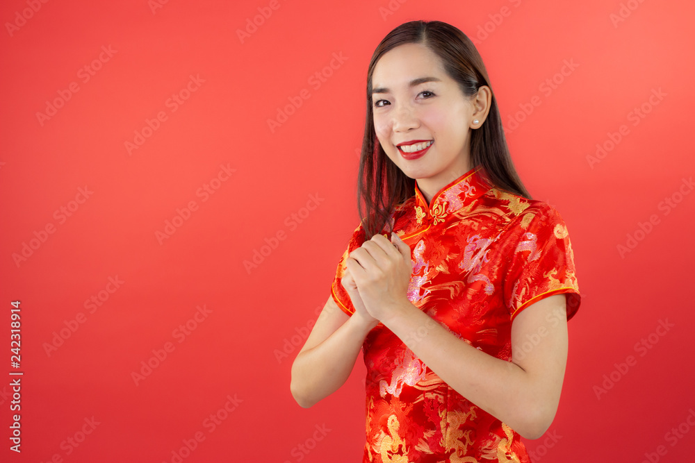chinese new year beautiful happy smiley asia chiness girl ware Qipao Oriental Chic Cheongsam with red background copy space isolated chinese new year beautiful happy smiley asia chiness girl ware Qipao Oriental Chic Cheongsam with red background copy space isolated