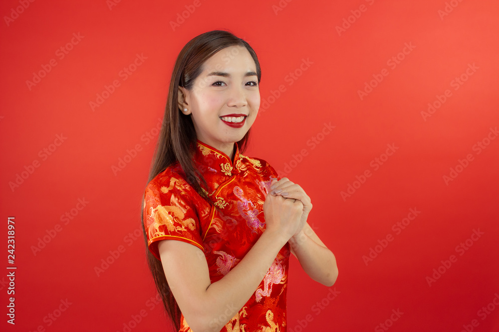 chinese new year beautiful happy smiley asia chiness girl ware Qipao Oriental Chic Cheongsam with red background copy space isolated chinese new year beautiful happy smiley asia chiness girl ware Qipao Oriental Chic Cheongsam with red background copy space isolated