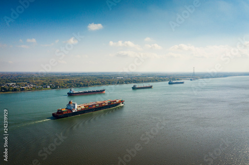 Fotografie Aerial view of a container ship going upstream in the St