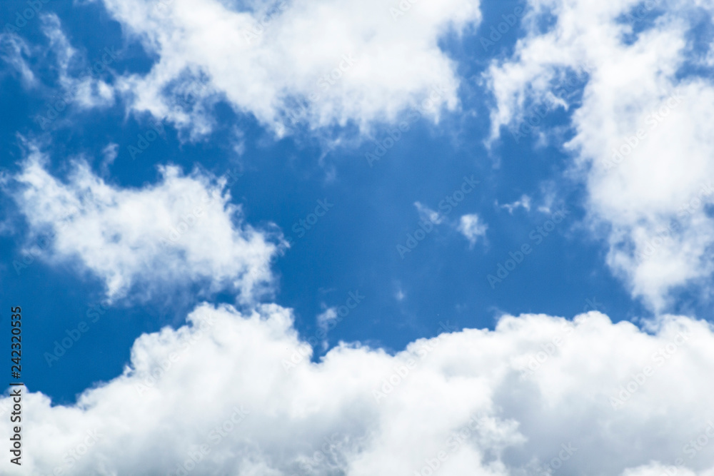 Fototapeta premium Beautiful blue sky background with clouds around