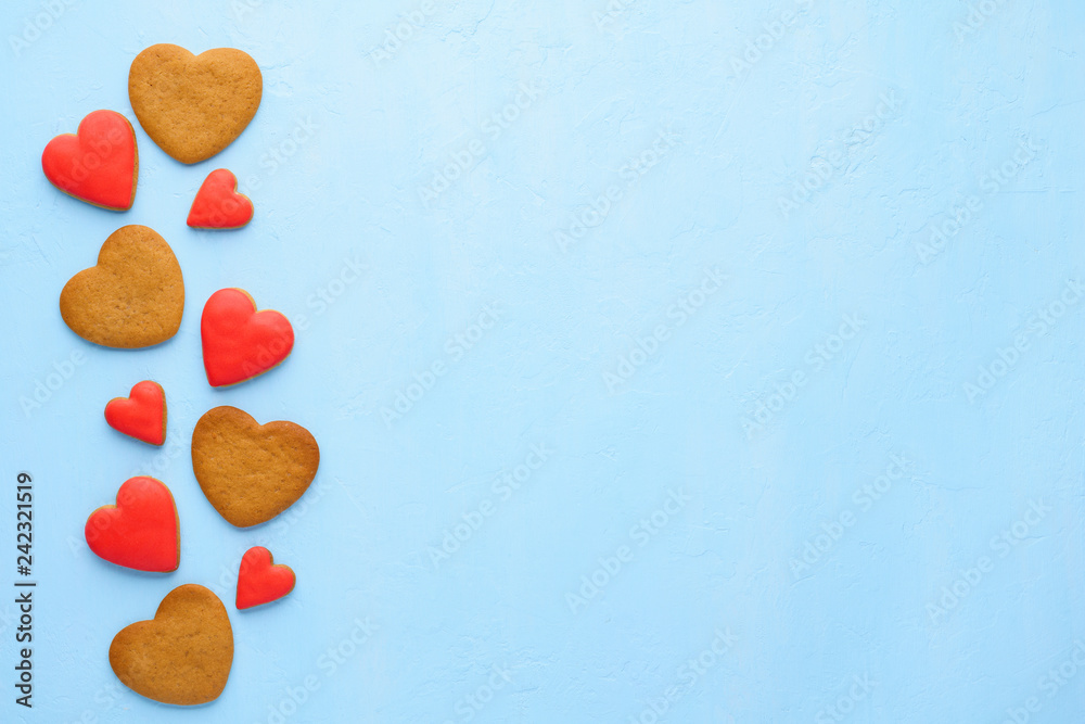 Fototapeta premium Red heart shaped cookies on blue background. Valentine's Day.