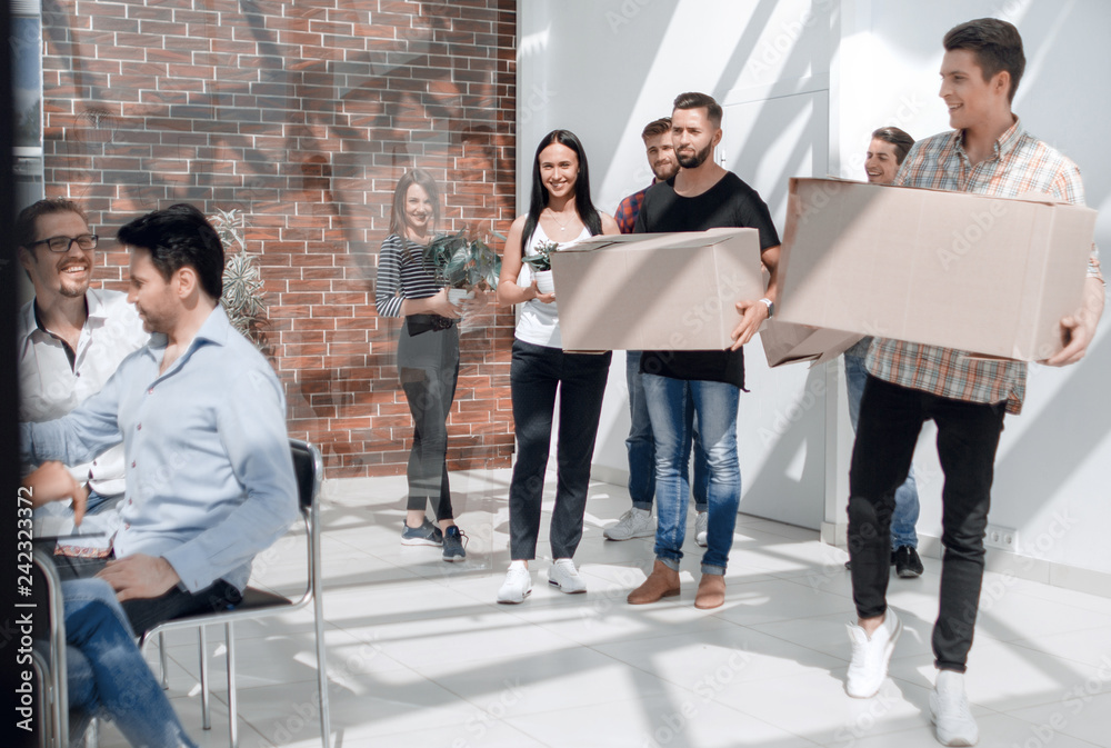 Fototapeta premium creative business team brings cardboard boxes to the new office