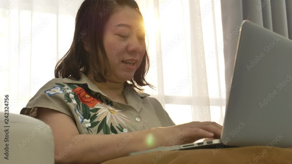Thailand woman using laptop with smile face at home. Thailand woman using laptop with smile face at home.