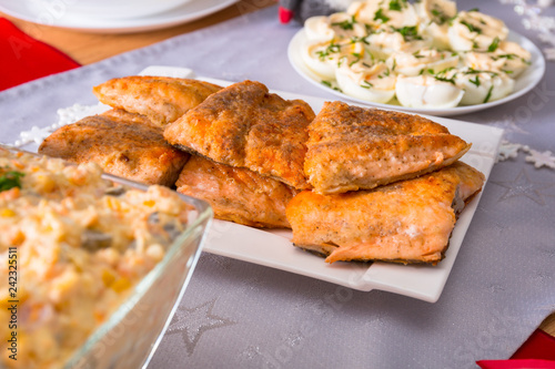 Christmas dinner table with fried salmon fillets and eggs mayonnaise © Patryk Kosmider