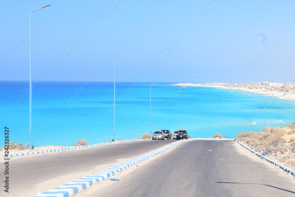 Enchanting beauty of a view for the sea while driving , with clear sky and rocky Enchanting beauty of a view for the sea while driving , with clear sky and rocky