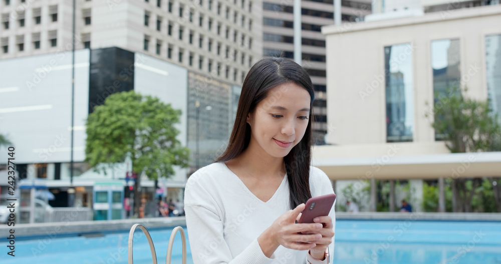 Woman use of mobile phone in city Woman use of mobile phone in city
