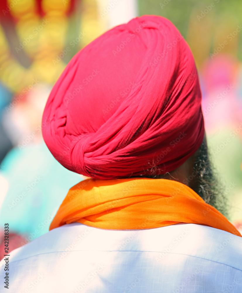 Senior man of Sikh religion with red turban during the religious Senior man of Sikh religion with red turban during the religious