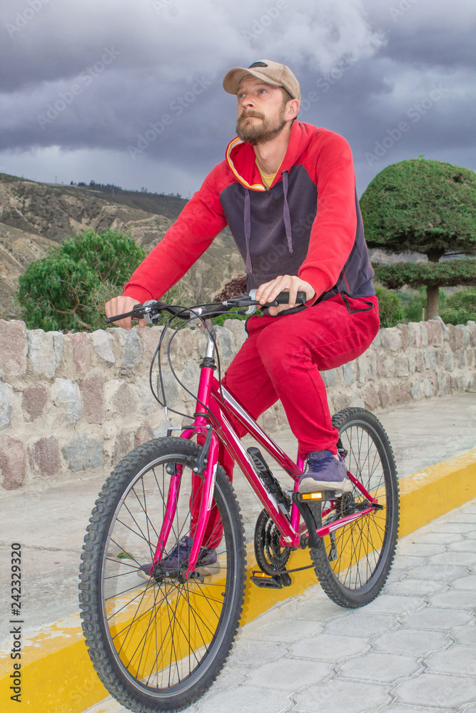 Fototapeta premium A man on a bicycle in the open air, rides along the road. Sports events, sports riding.