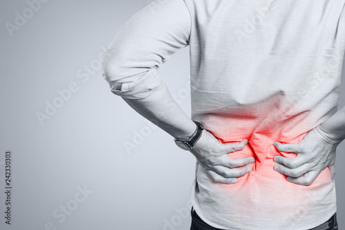 Man suffering from a lower back pain photo