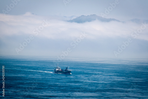 Boat in the sea with cloudy sky © Jonathan