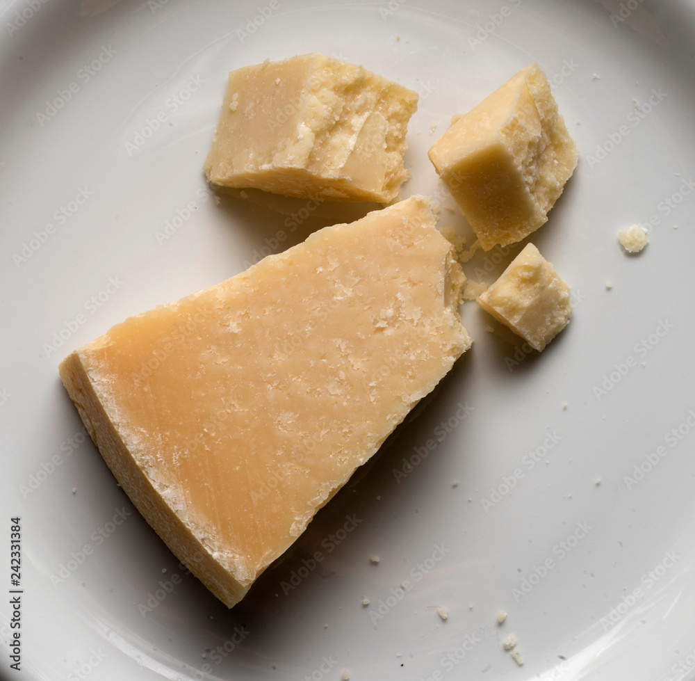 parmigiano reggiano, famous italian cheese, on white plate
