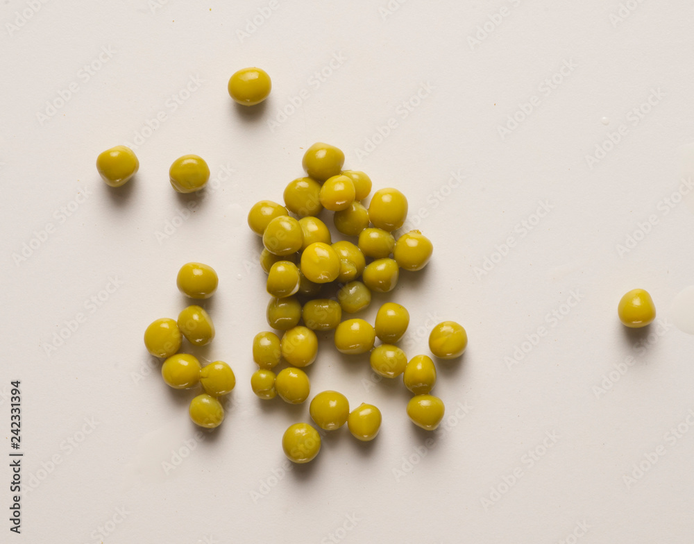 small pile of peas scattered on table, with shadow
small pile of peas scattered on table, with shadow