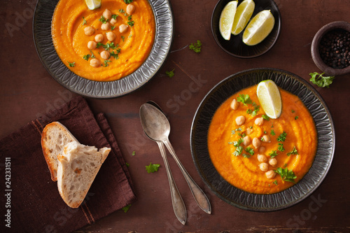 creamy carrot chickpea soup on dark rustic background