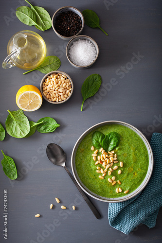 green creamy cauliflower spinach soup on gray background