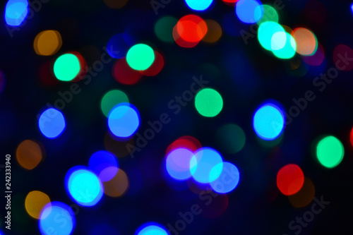 Bokeh. Christmas lights. Holiday background. Garland. Glitter. Defocused sparkles. Festive. New Year backdrop. Blinks. Carnival. Bokeh retro style photo. Multicolor. Colorful.