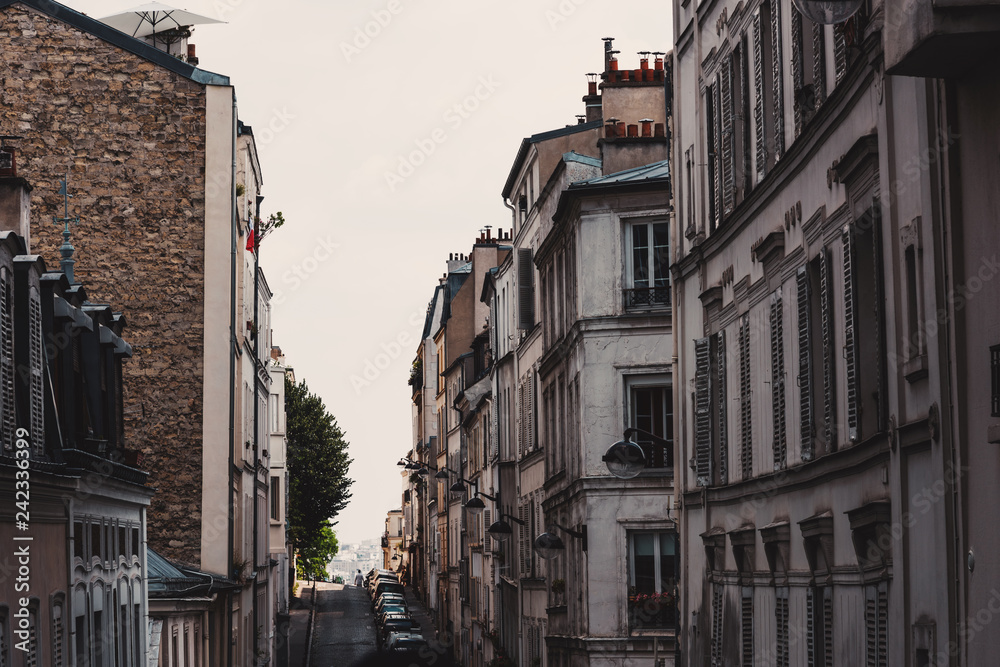 Fototapeta premium Narrow street and tall buildings in Montmartre