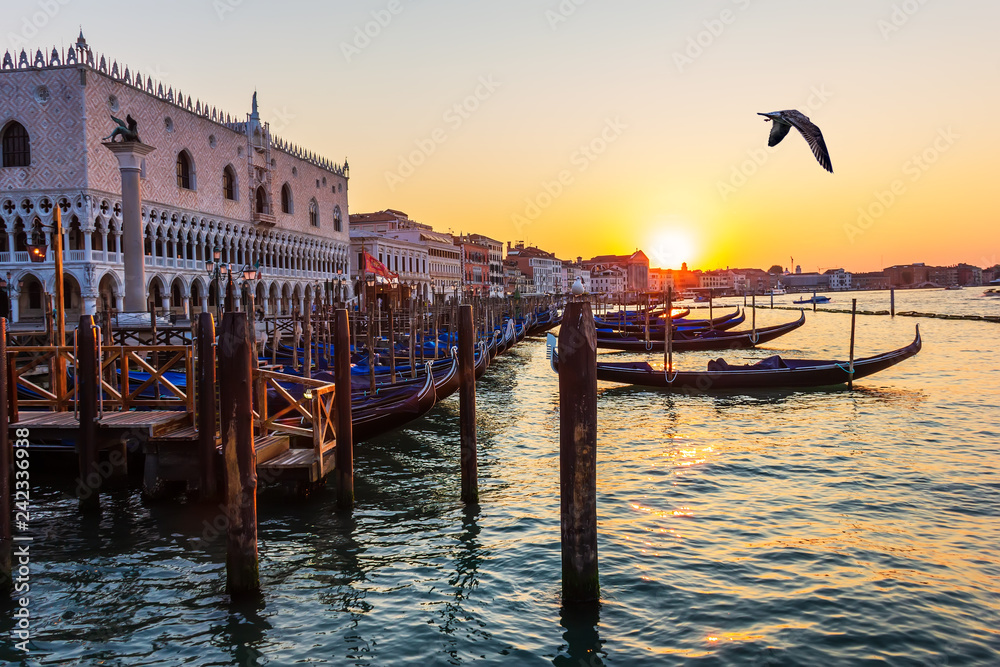 Doge's Palace and gondolas nearby at sunset, Venice, Italy