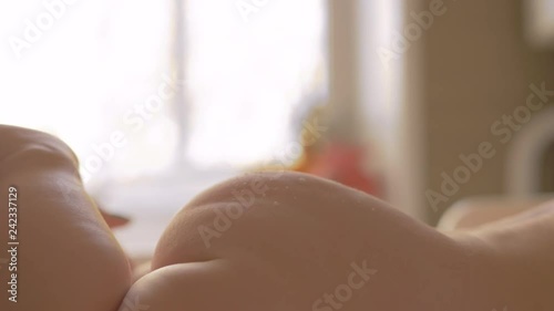 Close-up shot of mother applying baby powder to child gentle skin