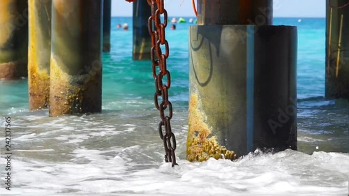 Waves of the Mediterranean Sea near pier. Summer vacation background