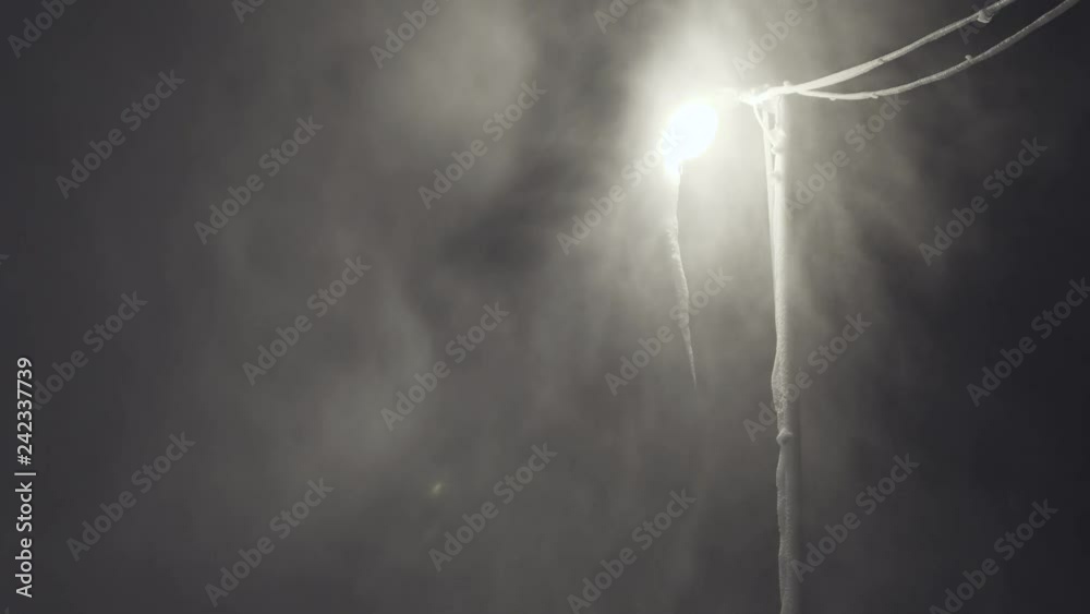 Lamp post at night in heavy snow storm