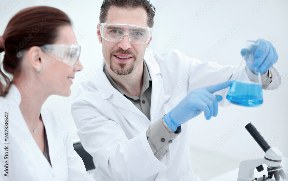 close up.two scientists discuss the results of testing. close up.two scientists discuss the results of testing.