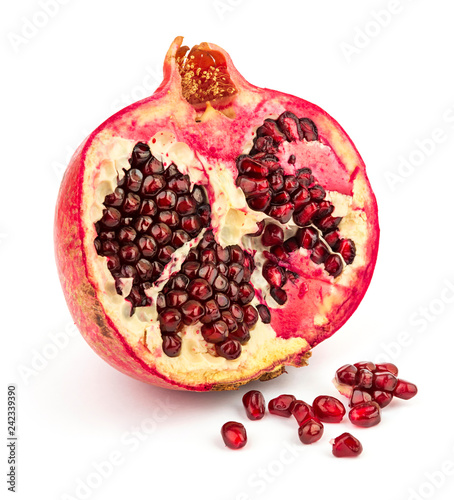 Pomegranate and seeds on white background