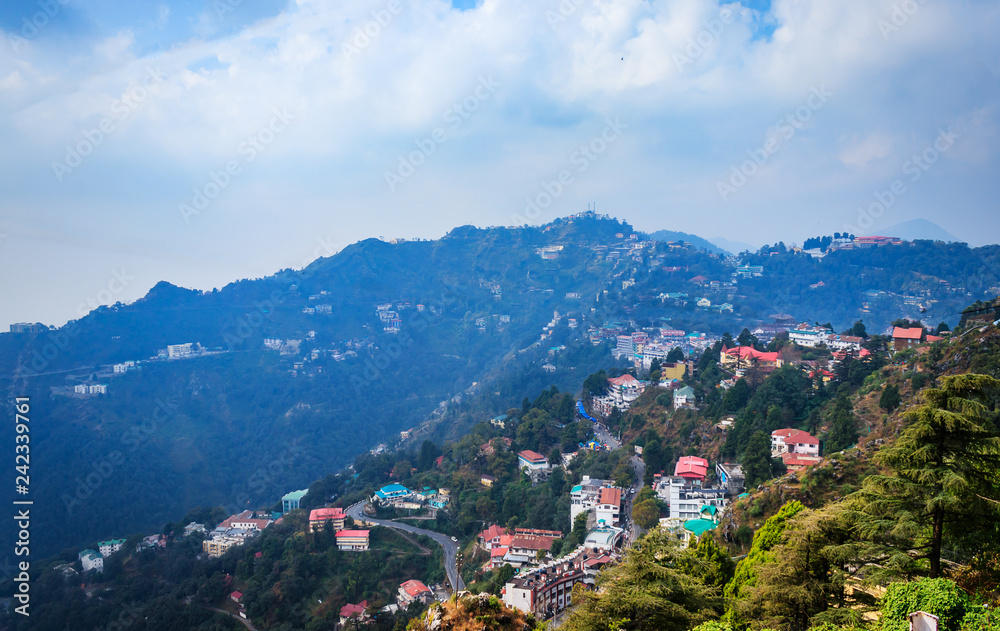 An Aerial landscape view of Mussoorie or Mussouri hill top peak city located in Uttarakhand India with colorful buildings