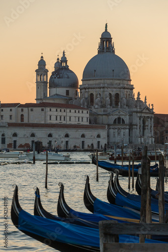 Santa Maria della Salute and gondola parking at sunset in Venice, Italy © Mazur Travel