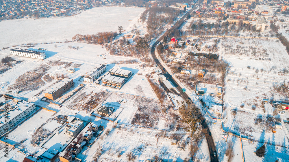 Aerial winter top down view high above rural slow living by small river.