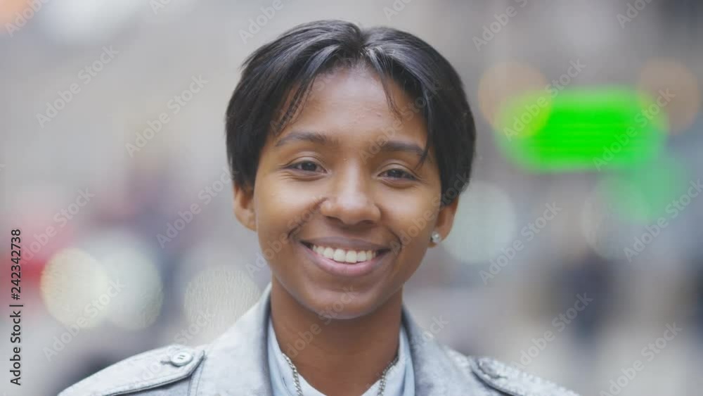 Portrait of happy transgender man smiling to camera in the street Portrait of happy transgender man smiling to camera in the street