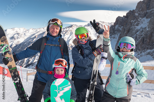 Happy family skiing at the mountains. Kids in ski school.