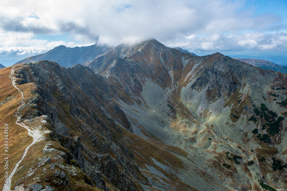 rocky Tatra mountain tourist hiking trails under blue sky in Slovakia