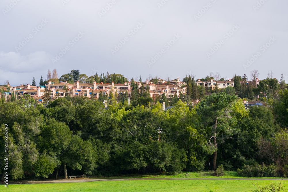 Residential buildings at the edge of a park on a stormy day, south San Francisco bay area, California