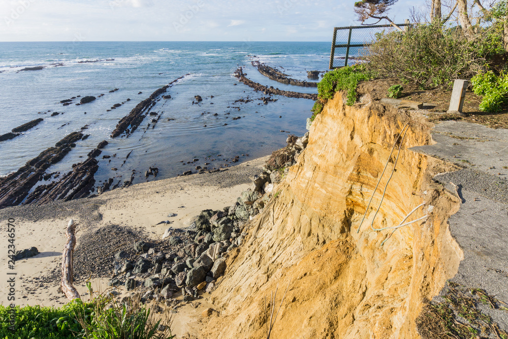 Collapsed paved road due to a landslide on the Pacific Ocean coastline, Moss Beach California