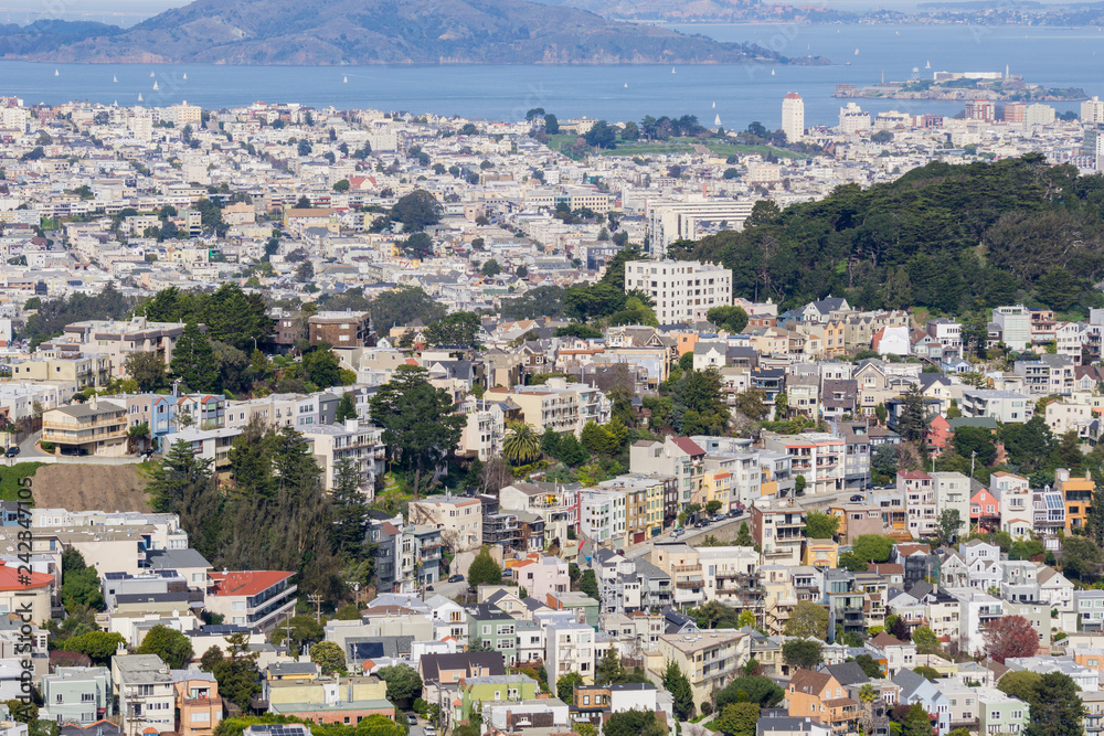 Aerial view of residential areas of San Francisco; San Francisco bay and Alcatraz island in the background, California