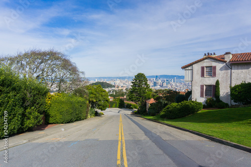 Two way street in the residential area of San Francisco; downtown views in the background, California