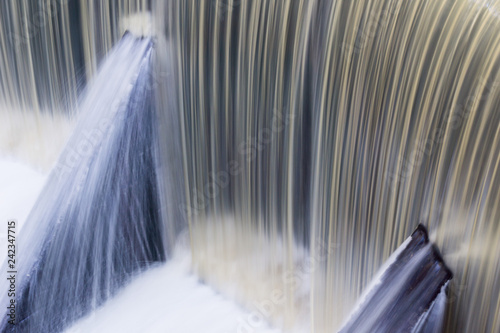 Fast flowing water over a concrete dam, California; long exposure