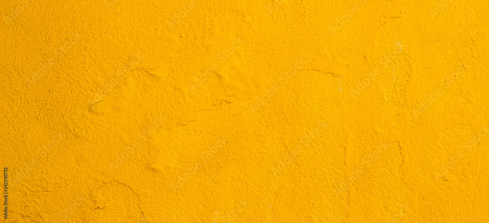 Old cracked yellow painted wall background Old cracked yellow painted wall background